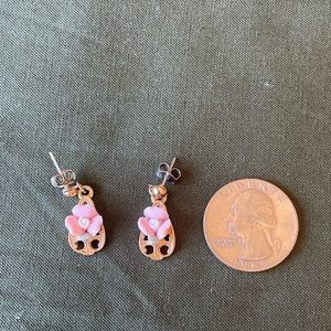 Vintage porcelain flower earrings on gold background.